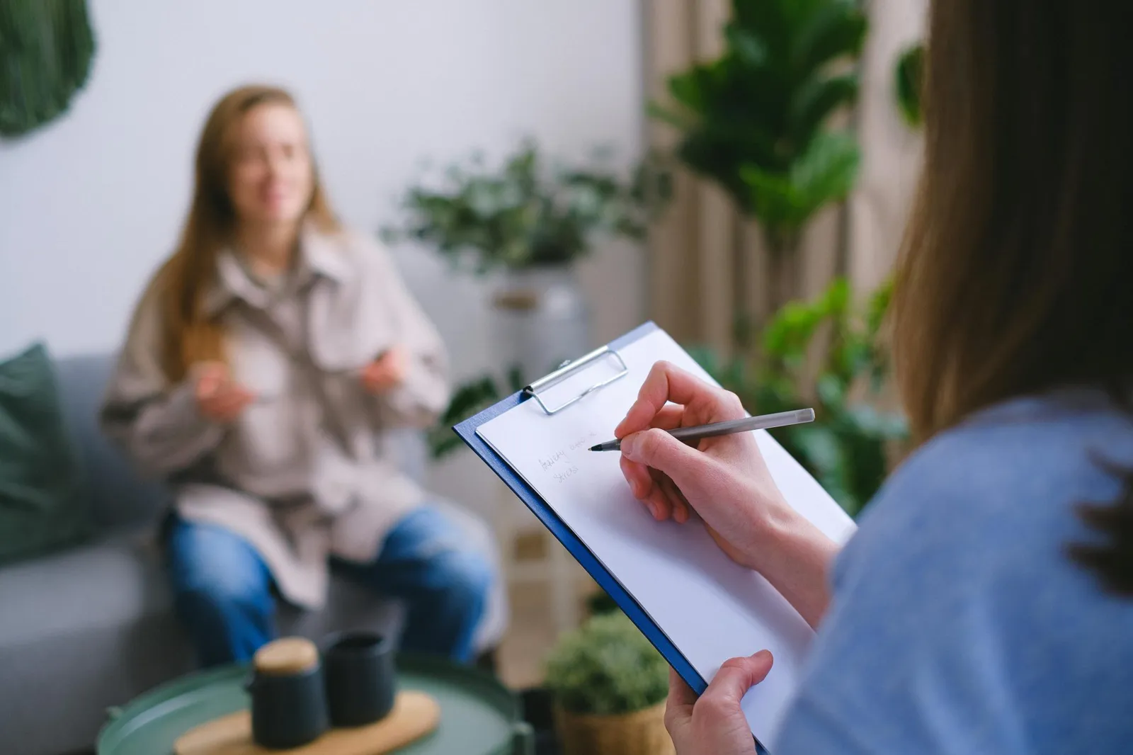 Interviewer taking notes during a customer conversation